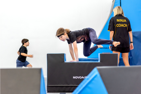 Ninja participant jumping over blocks