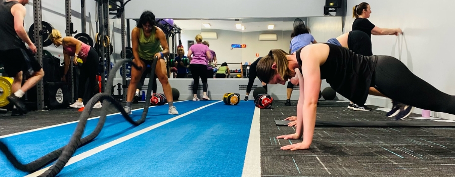 group of adults utilising different fitness equipment in a room