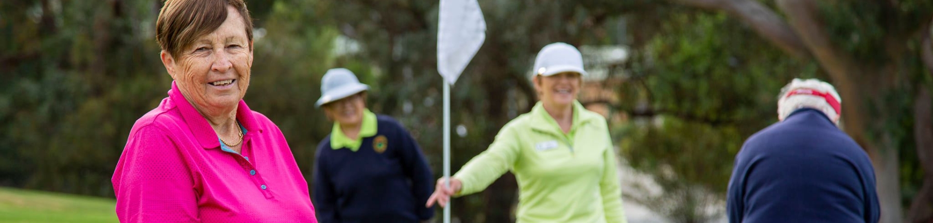 group of women playing golf on the course