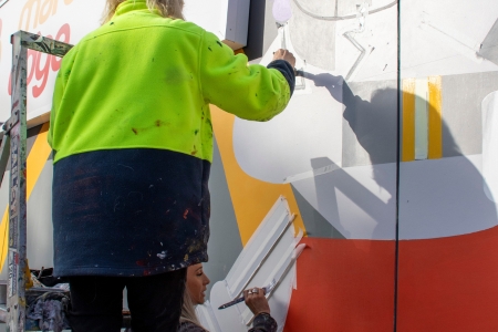 Brigitte and Melissa working on the mural at the same time